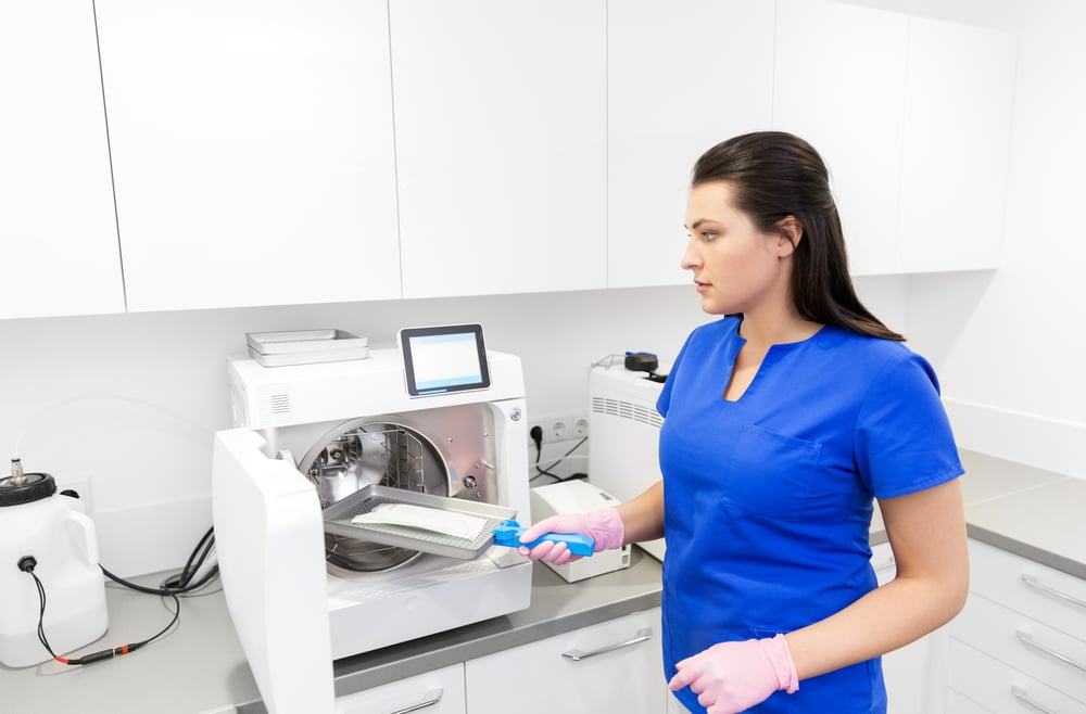 a sterilization nurse handling medical equipment